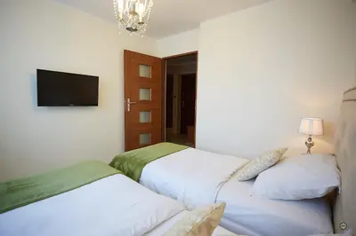 Łóżko lub łóżka w pokoju w obiekcie APARTAMENT IZABEL