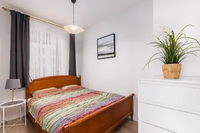 Łóżko lub łóżka w pokoju w obiekcie BG Apartments Grzybowska