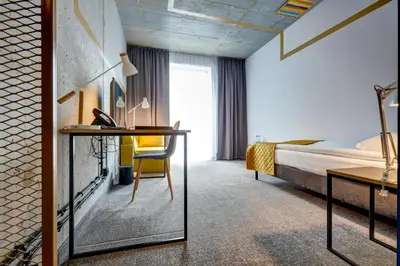Łóżko lub łóżka w pokoju w obiekcie Hotel Arche Geologiczna