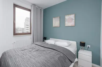 Łóżko lub łóżka w pokoju w obiekcie Chill Apartments Wola