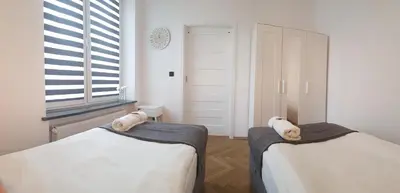 Łóżko lub łóżka w pokoju w obiekcie Apartamenty Planet