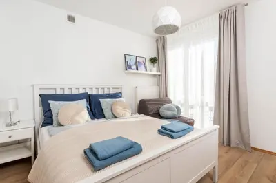Łóżko lub łóżka w pokoju w obiekcie Jonagold Apartment Metro Raclawicka