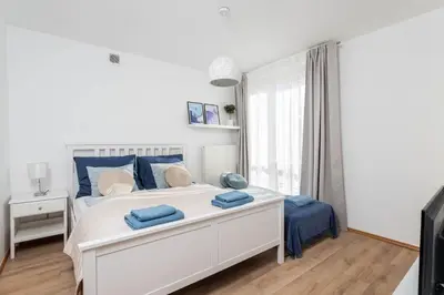 Łóżko lub łóżka w pokoju w obiekcie Jonagold Apartment Metro Raclawicka