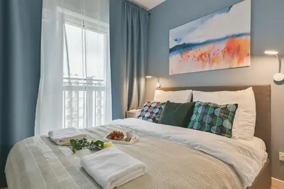 Łóżko lub łóżka w pokoju w obiekcie Airport Okecie Wagonowa Serviced Apartments