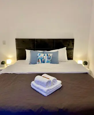 Łóżko lub łóżka w pokoju w obiekcie Living Point Residence Center