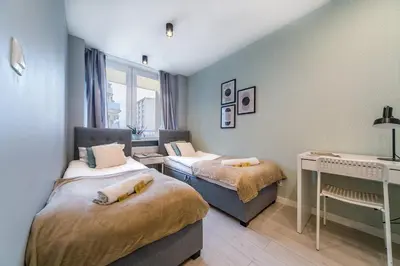 Łóżko lub łóżka w pokoju w obiekcie Warsaw Concierge Silver Apartment