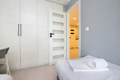 Łóżko lub łóżka w pokoju w obiekcie Warsaw Concierge Silver Apartment
