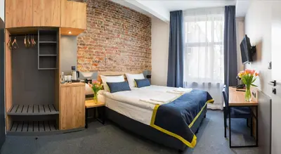 Łóżko lub łóżka w pokoju w obiekcie Hotel Mokotów