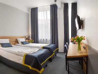 Łóżko lub łóżka w pokoju w obiekcie Hotel Mokotów