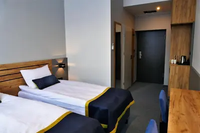 Łóżko lub łóżka w pokoju w obiekcie Hotel Mokotów