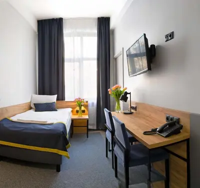Łóżko lub łóżka w pokoju w obiekcie Hotel Mokotów