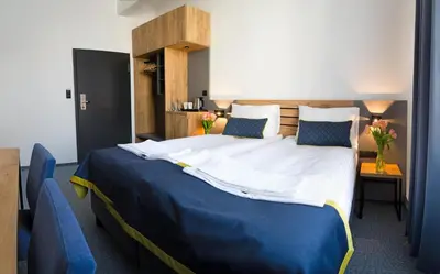 Łóżko lub łóżka w pokoju w obiekcie Hotel Mokotów