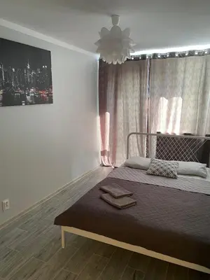 Łóżko lub łóżka w pokoju w obiekcie Coser Apartamenty Metro ONZ