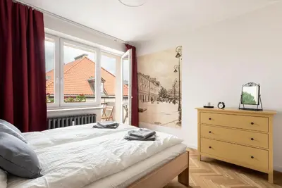 Łóżko lub łóżka w pokoju w obiekcie Apartament Ogród Krasińskich