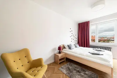 Łóżko lub łóżka w pokoju w obiekcie Apartament Ogród Krasińskich