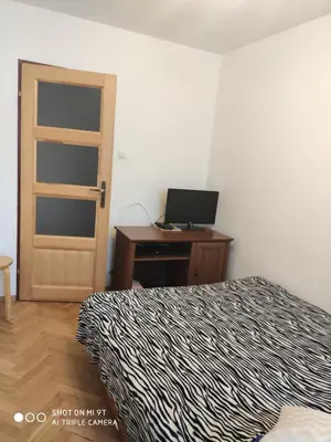 Łóżko lub łóżka w pokoju w obiekcie Anita Apartament Nowowiejska