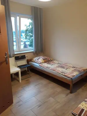 Łóżko lub łóżka w pokoju w obiekcie Noclegi Pod Kasztanami