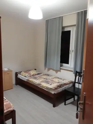 Łóżko lub łóżka w pokoju w obiekcie Noclegi Pod Kasztanami