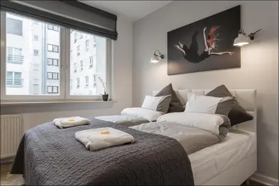 Łóżko lub łóżka w pokoju w obiekcie P&O Serviced Apartments NOWOGRODZKA