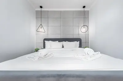 Łóżko lub łóżka w pokoju w obiekcie Apartament Zielna by Your Freedom