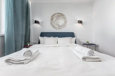 Łóżko lub łóżka w pokoju w obiekcie Apartament Zielna by Your Freedom