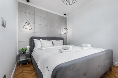Łóżko lub łóżka w pokoju w obiekcie Apartament Zielna by Your Freedom