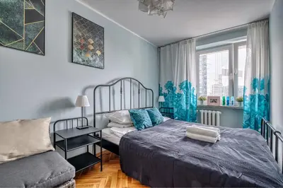 Łóżko lub łóżka w pokoju w obiekcie WeLive - Center, E.Plater 55