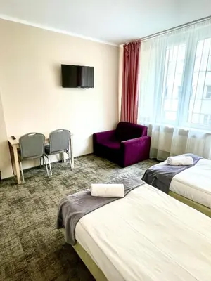 Łóżko lub łóżka w pokoju w obiekcie eMKa Hostel