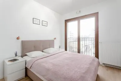 Łóżko lub łóżka w pokoju w obiekcie Chill Apartments Mokotów Residence