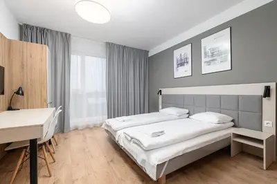 Łóżko lub łóżka w pokoju w obiekcie RentPlanet - Apartamenty Wolska