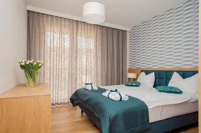 Łóżko lub łóżka w pokoju w obiekcie ShortStayPoland Apartamenty