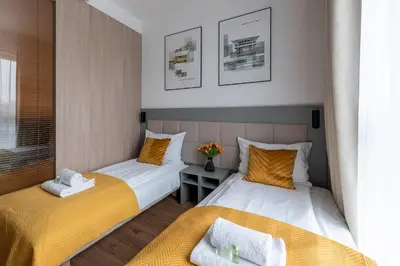 Łóżko lub łóżka w pokoju w obiekcie Aparthotel City Break Wolska