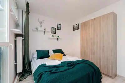 Łóżko lub łóżka w pokoju w obiekcie ShortStayPoland Krochmalna (B17)