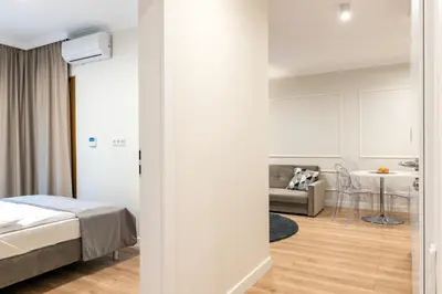 Łóżko lub łóżka w pokoju w obiekcie Mennica Residence I