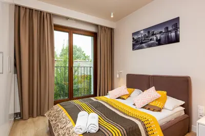 Łóżko lub łóżka w pokoju w obiekcie Apartments Warsaw Magazynowa by Noclegi Renters