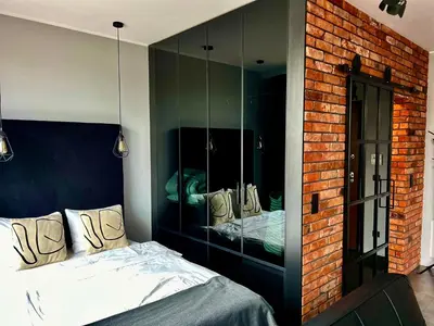 Łóżko lub łóżka w pokoju w obiekcie Loft Apartment Browary Warszawskie