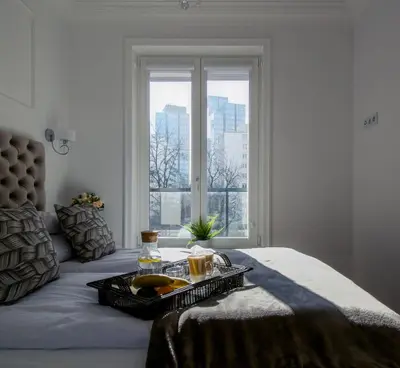 Łóżko lub łóżka w pokoju w obiekcie Warsaw Seasons by Alluxe Boutique Apartments