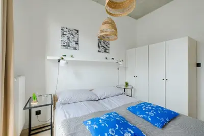 Łóżko lub łóżka w pokoju w obiekcie Apartamenty Patriotów 303