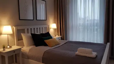 Łóżko lub łóżka w pokoju w obiekcie Grochowska Apartment