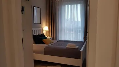 Łóżko lub łóżka w pokoju w obiekcie Grochowska Apartment