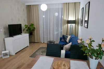 Telewizja i/lub zestaw kina domowego w obiekcie Oś Królewska - Modern Apartment in Wilanów