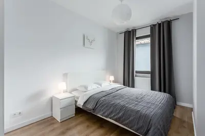 Łóżko lub łóżka w pokoju w obiekcie Warsaw City Apartments