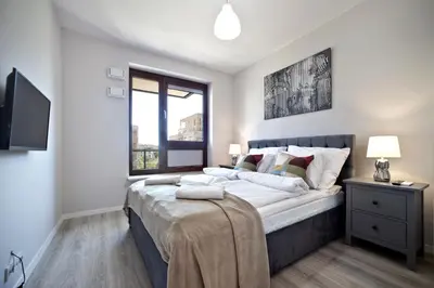Łóżko lub łóżka w pokoju w obiekcie Marina Mokotow P&O Serviced Apartments