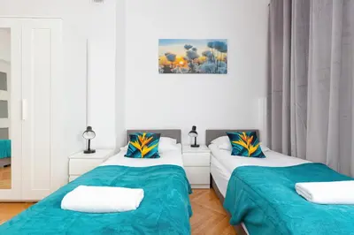 Łóżko lub łóżka w pokoju w obiekcie Kamienica Stanisława Augusta Warszawa by Noclegi Renters