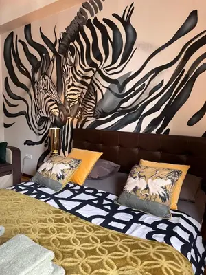 Łóżko lub łóżka w pokoju w obiekcie Africa Apartment