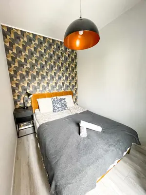 Łóżko lub łóżka w pokoju w obiekcie SuperApart Wileńska apt29 - Komfort na warszawskiej Pradze