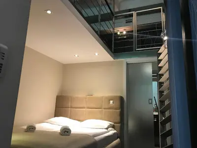 Łóżko lub łóżka w pokoju w obiekcie Apart Lofts Car Factory by WarsawResidence Group