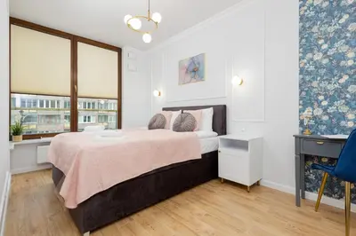 Łóżko lub łóżka w pokoju w obiekcie Apartamenty Ogrodowa Business Wola by Renters Prestige