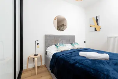 Łóżko lub łóżka w pokoju w obiekcie Atrium Promenada Apartments Gocław by Noclegi Renters