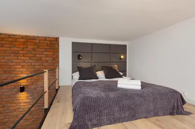 Łóżko lub łóżka w pokoju w obiekcie Mezzanine Studio Lwowska Śródmieście by Noclegi Renters